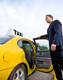 Male driver opening the door of the taxi